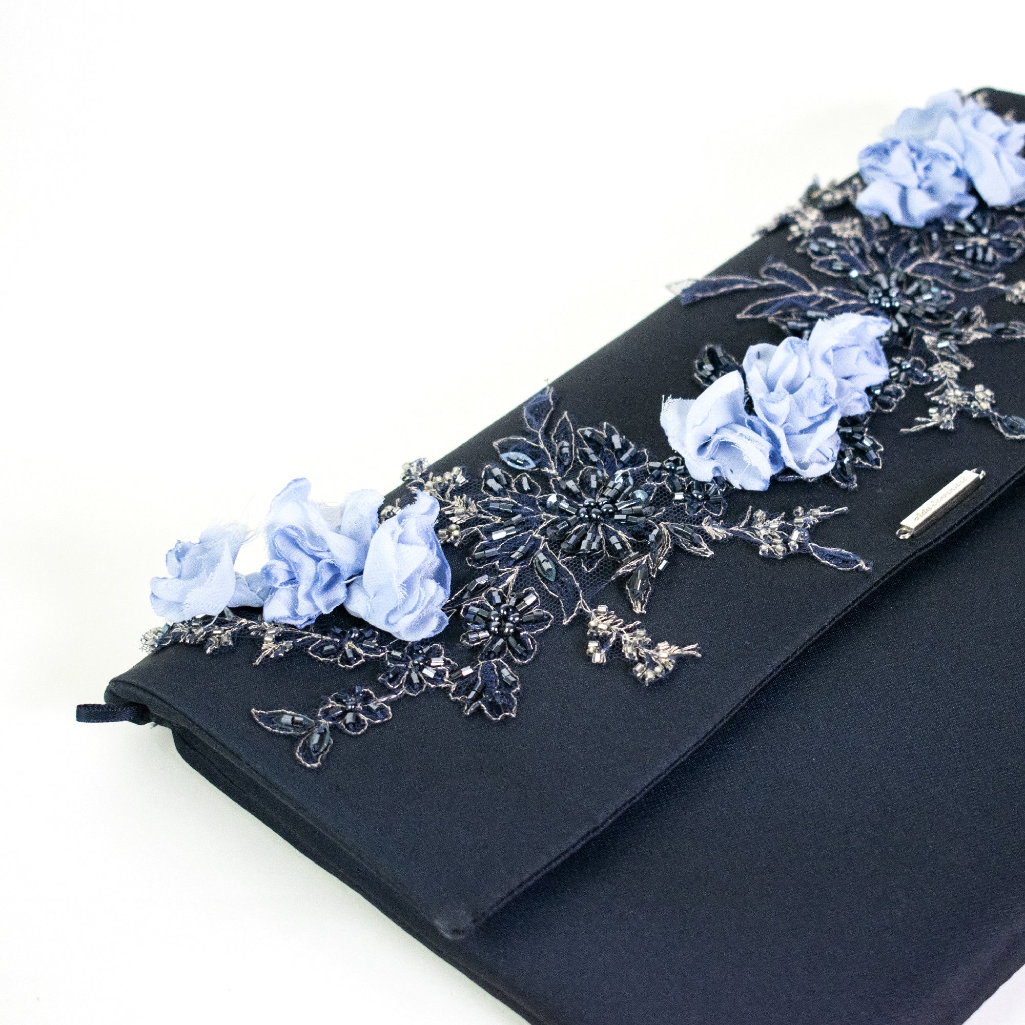 Blue clutch bag with three-dimensional flowers