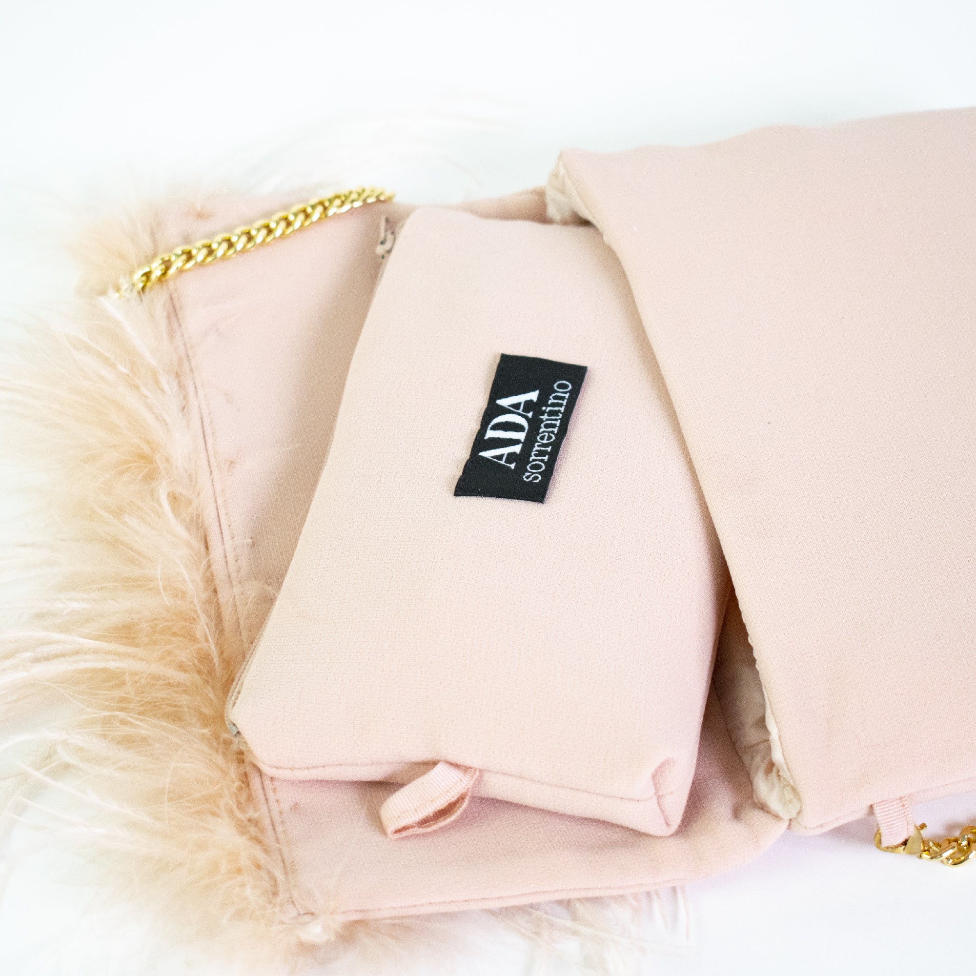 Pink clutch bag with feathers